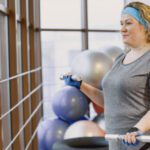 Fat woman dieting, fitness. Portrait of obese woman working out in gym.